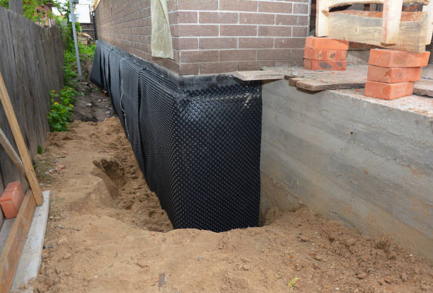 Happy homeowners after waterproofing job in Cory